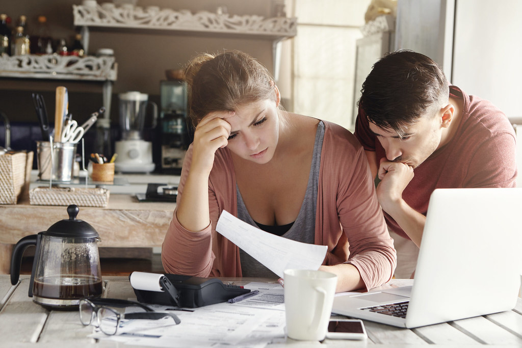 Homeowner couple managing household finances and debt consolidation